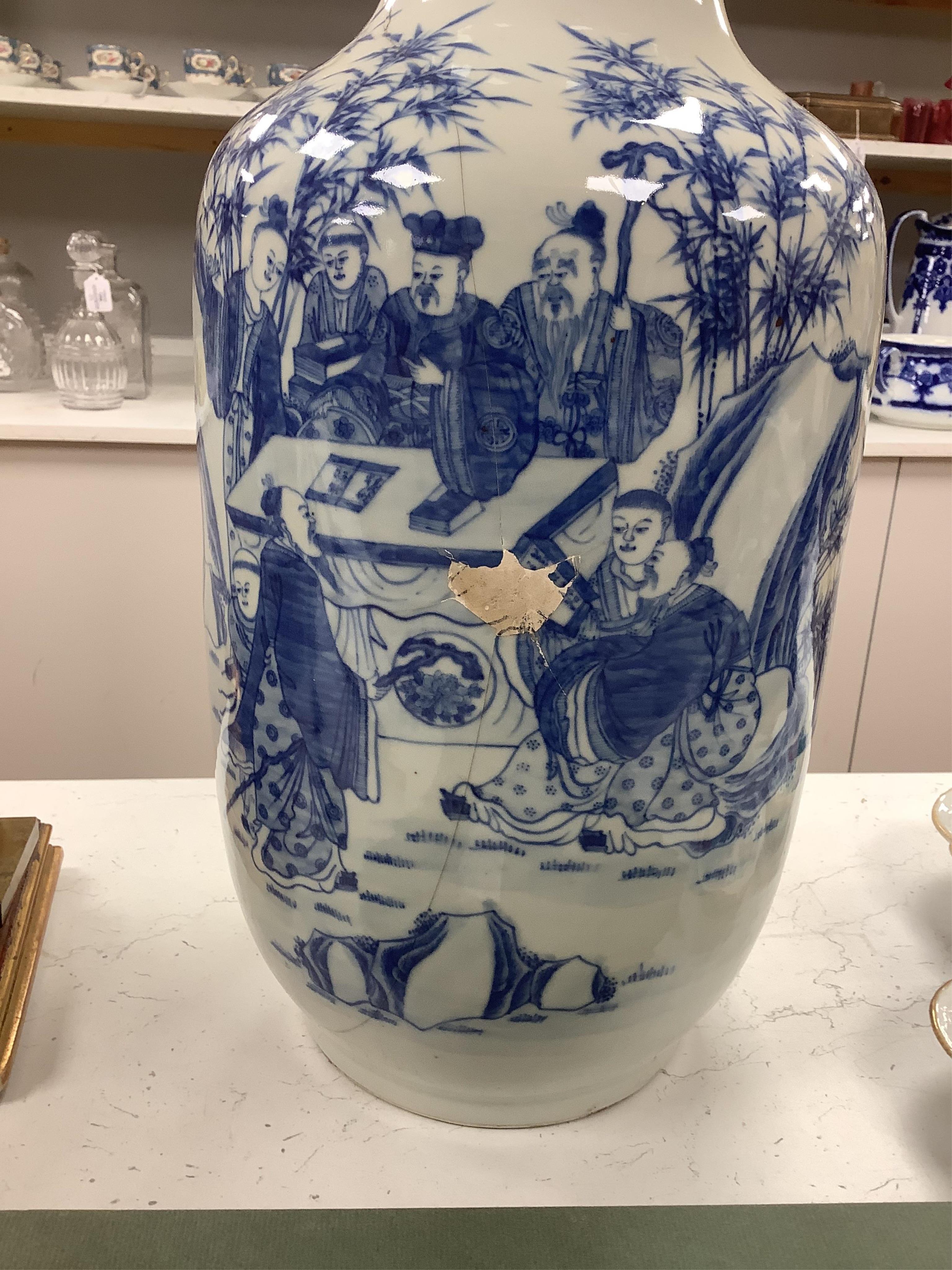 A large Chinese blue and white figural vase. 46cm high. Condition - large crack through from top to bottom of vase.